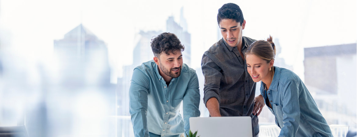 Business team viewing E-Learning tutorial together on a laptop computer